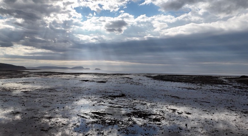 Sunbeams over the Bay of Fundy tidal flats at low tide near Two Islands