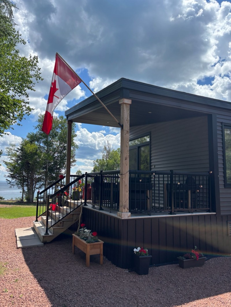 The covered deck with a Canadian flag and the bay beyond