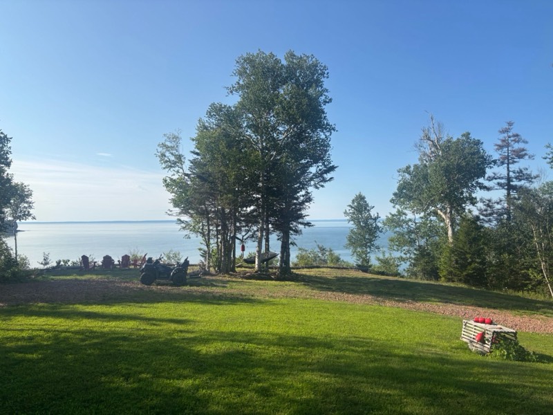 The lawn, hammock and fire pit chairs looking out over the Bay of Fundy