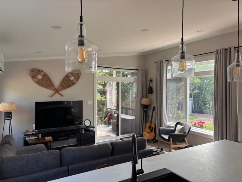 Living room with vintage snowshoes on the wall and sliding doors to the covered deck